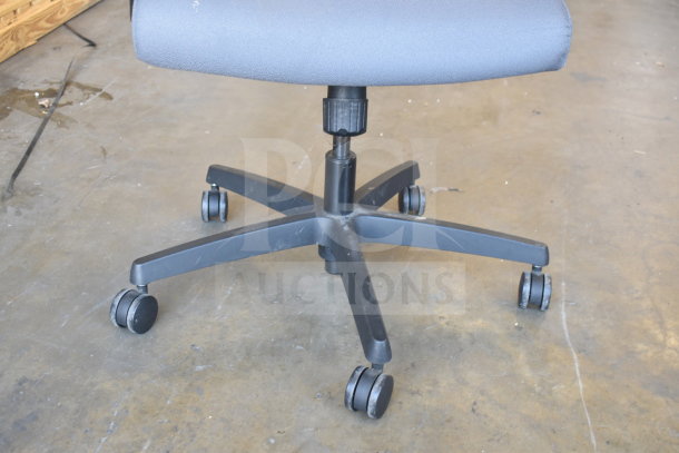 Set of 12 office chairs on casters, adjustable height, fabric seat, showing minor wear. Sold in bulk, enhancing bid value.