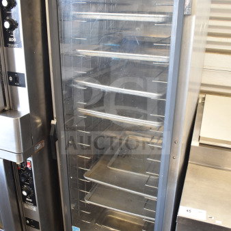 Metro 519-CFC-4 heated holding cabinet on casters, stainless steel, clear door, adjustable shelves, controls visible.