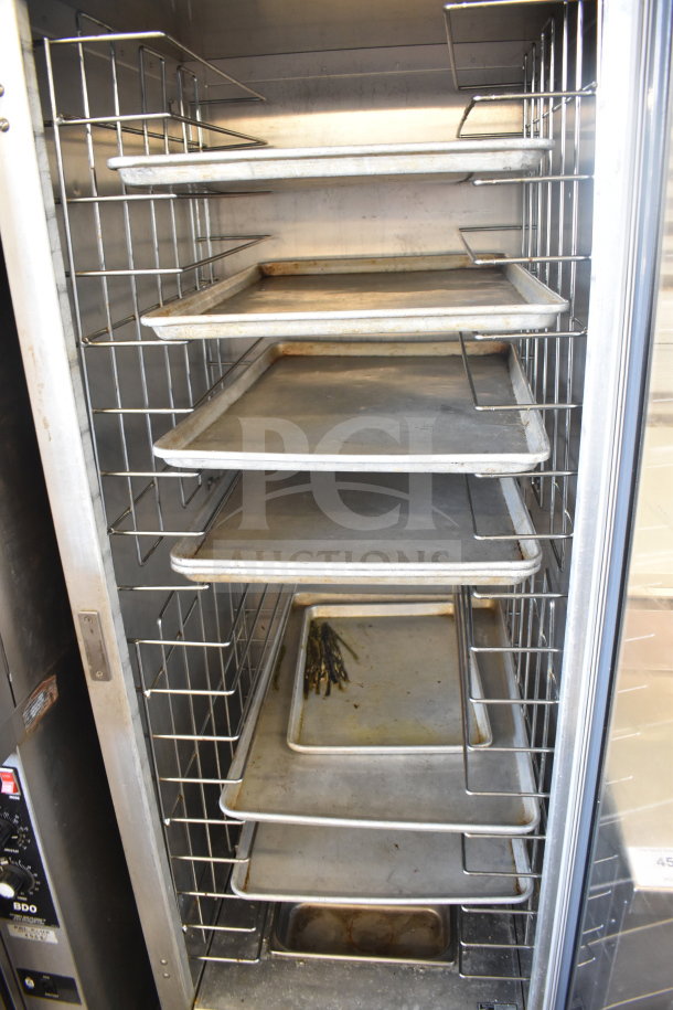 Metro 519-CFC-4 heated holding cabinet with multiple trays on commercial casters; used condition, interior view.