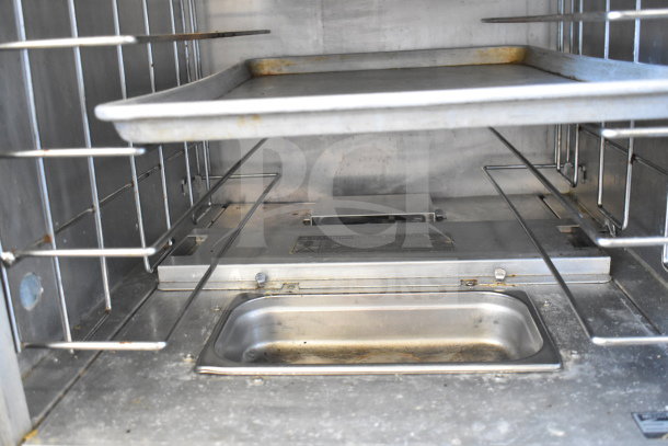 Metro 519-CFC-4 commercial heated holding cabinet interior view, showing metal racks and heating tray, some wear visible.
