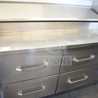 Commercial pizza prep table with 4 drawers, stainless steel, on casters, 115 volts, 1 phase, excellent condition.
