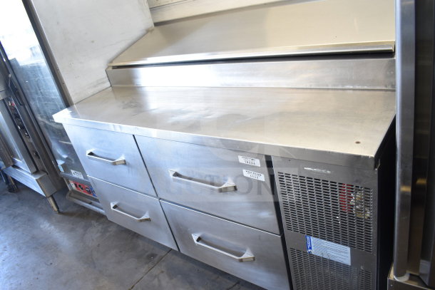 Commercial pizza prep table with 4 drawers, stainless steel, on casters. 115 Volts, 1 Phase. Minor surface wear. Labels visible.