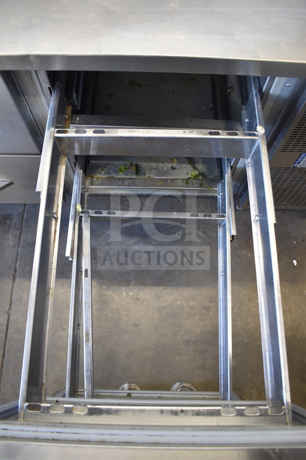 Commercial pizza prep table with four drawers on commercial casters, shown with open drawer frames. 115V, 1 phase.