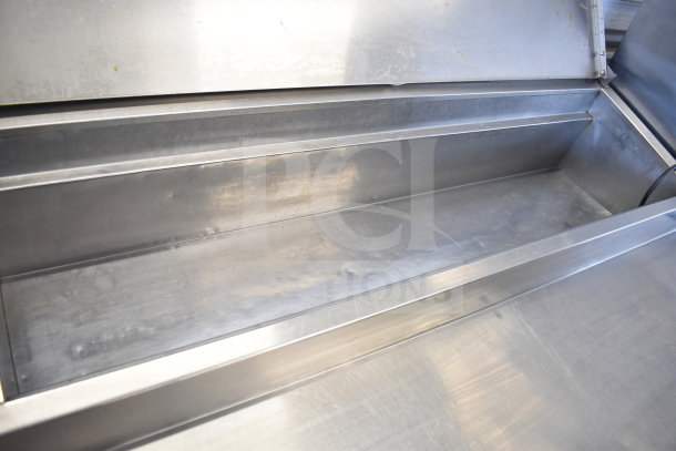 Commercial pizza prep table with 4 drawers on casters, stainless steel, 115 volts, 1 phase, used condition.