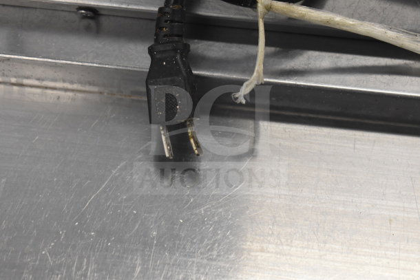 Avantco 178SSPT60MHC prep table showing electrical plug and stainless steel surface, indicating commercial use.