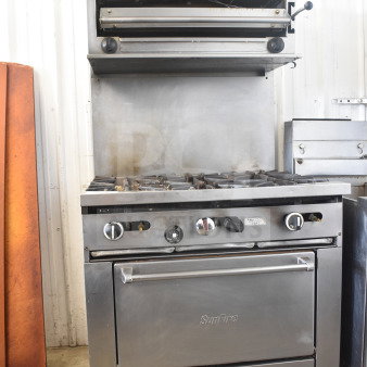 Garland SunFire commercial gas 6-burner range with salamander cheese melter, oven, and overshelf.