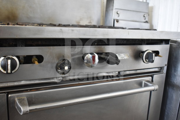 Garland SunFire commercial gas range with 6 burners, salamander cheese melter, oven, and over shelf. Metal finish, used condition.