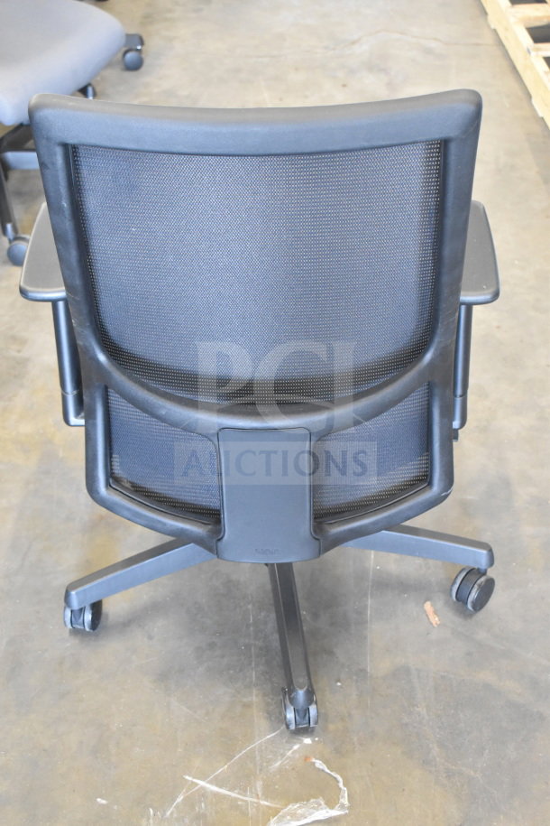 Mesh office chair on casters, black frame, ergonomic design, adjustable armrests. Auction lot of 16 chairs.