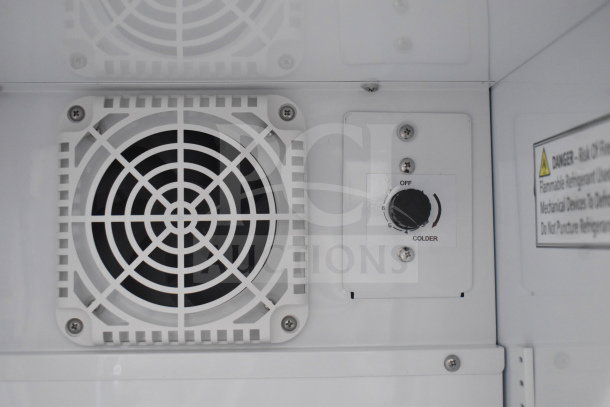 Inside view of IDW G-4SI-N-2-3-4-B-5 cooler, showing fan and temperature control dial. Warning label visible.