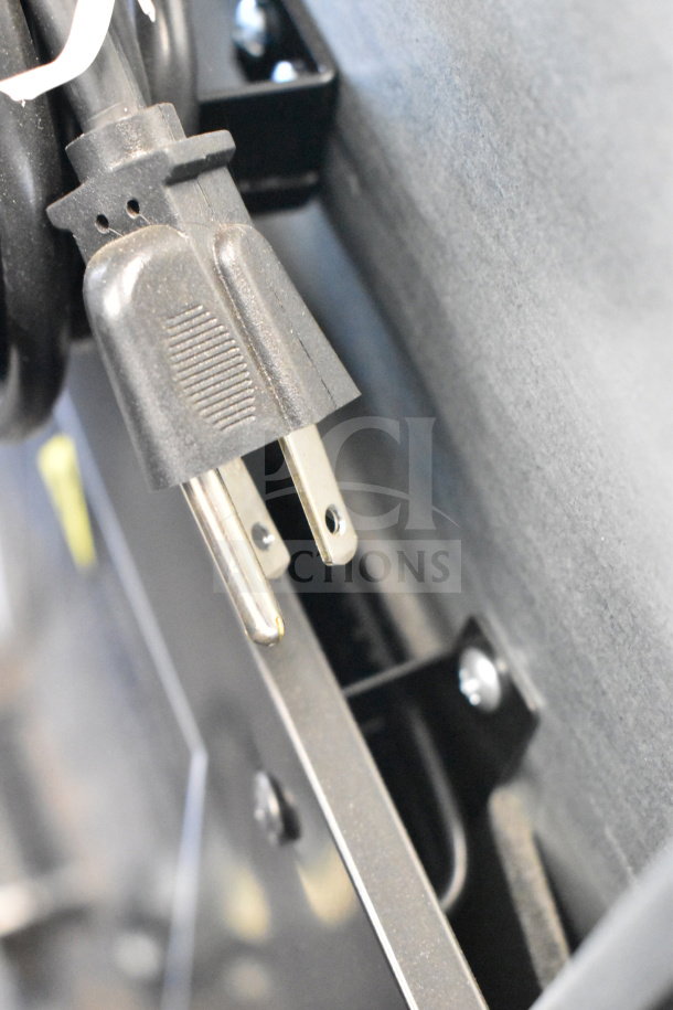 Close-up of the power cord plug for the IDW G-4SI-N-2-3-4-B-5 cooler, showing standard 110-120V connection.