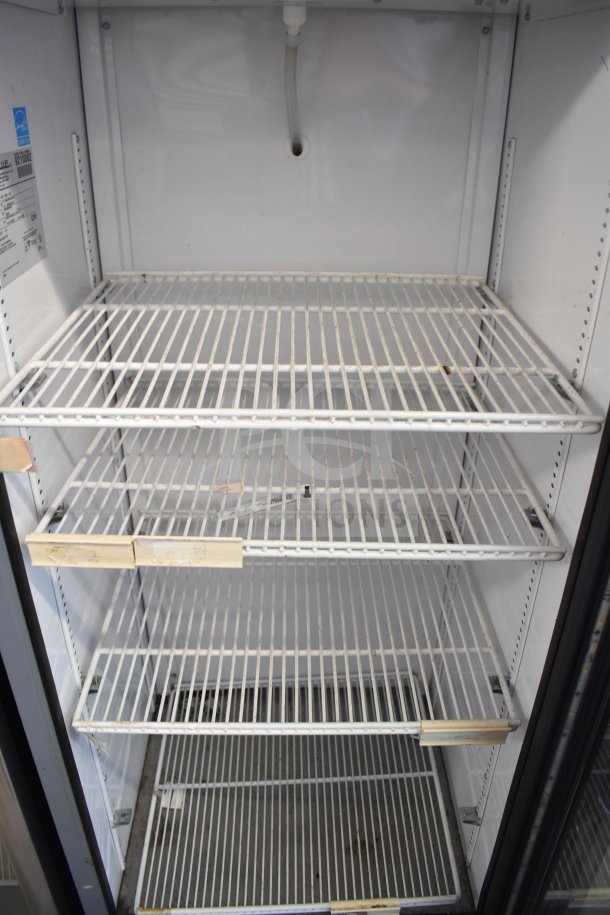 2018 True GDM-12-HC-LD commercial cooler with four wire shelves, 115 volts, 1 phase. Clean interior, minor wear visible.