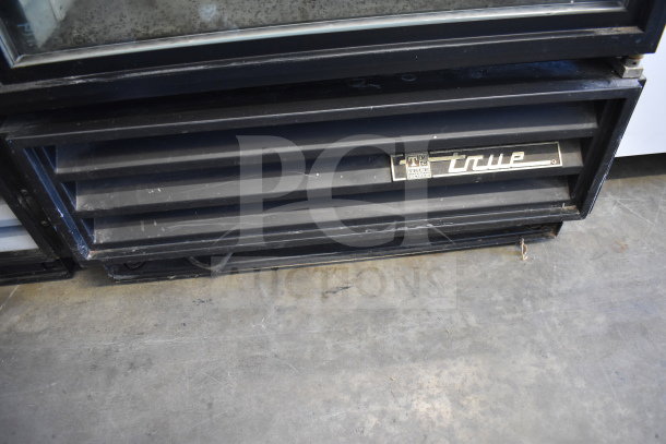 True GDM-12 Commercial Cooler, single door, 115V, visible logo, black exterior, in used condition.