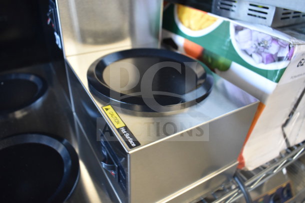 Brand new Avantco 177C30 pourover coffee maker with 3 warmers, 120 volts, slight scratches. Warning label: "Caution Hot Surface."