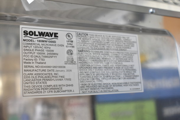 Stainless steel Solwave 180MW1000D commercial microwave, 120 volts, 1 phase, brand new with scratches and dents, model label visible.
