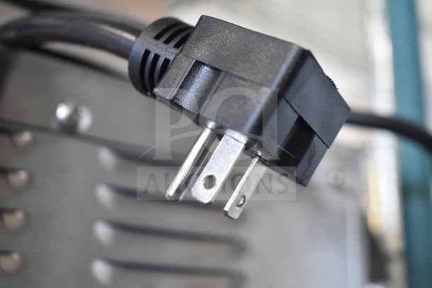 Close-up of a power plug of an Avantco 184T140 conveyor toaster, showcasing its 120V compatibility.