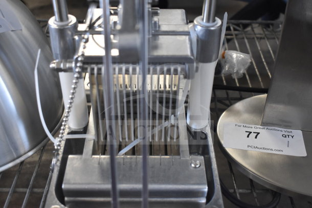 "Brand new countertop cooked chicken slicer, stainless steel, slight scratches, includes auction tag number 77."