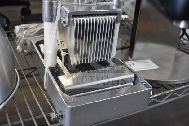 Brand new countertop cooked chicken slicer with minor scratches and dents. Stainless steel blades, sturdy construction, item 77 tag visible.