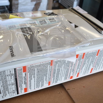 Brand new Rinnai V53De gas wall-mounted outdoor tankless water heater, 120V, 120,000 BTU, 5.3 GPM, with minor scratches.