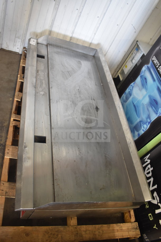 Brand new Avantco 177CAG60 60" gas griddle, thermostatic controls, minor scratches, marks; on wooden pallet.
