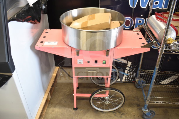 Carnival King 382CCM21CT cotton candy machine with 21" stainless steel bowl and pink cart. Brand new, scratch and dent.