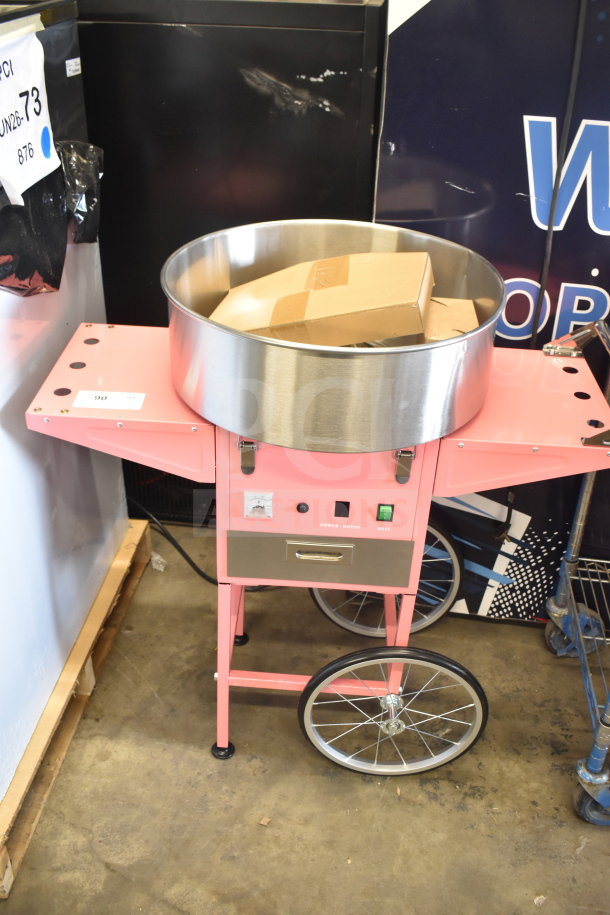 Brand new Carnival King cotton candy machine, model 382CCM21CT, with 21" stainless steel bowl and cart. Slight scratches.
