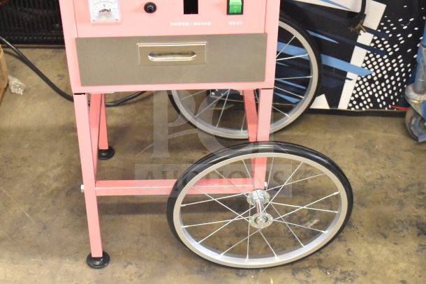 BRAND NEW Carnival King cotton candy machine with pink cart, 21" stainless bowl, 110V, 1-phase. Model: 382CCM21CT.