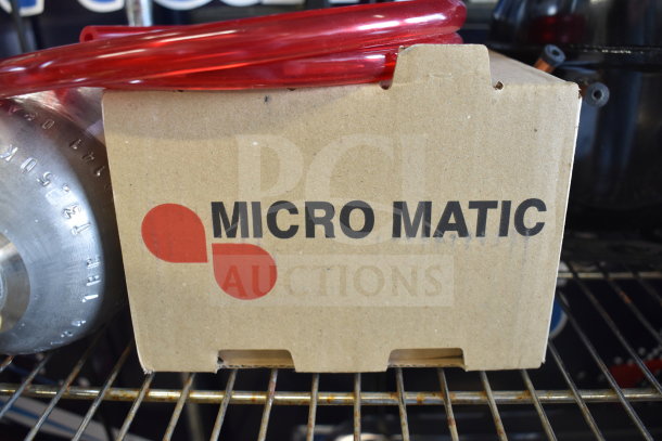 Cardboard box labeled "MICRO MATIC" with red tubing on top. New condition, scratch and dent, pickup only.