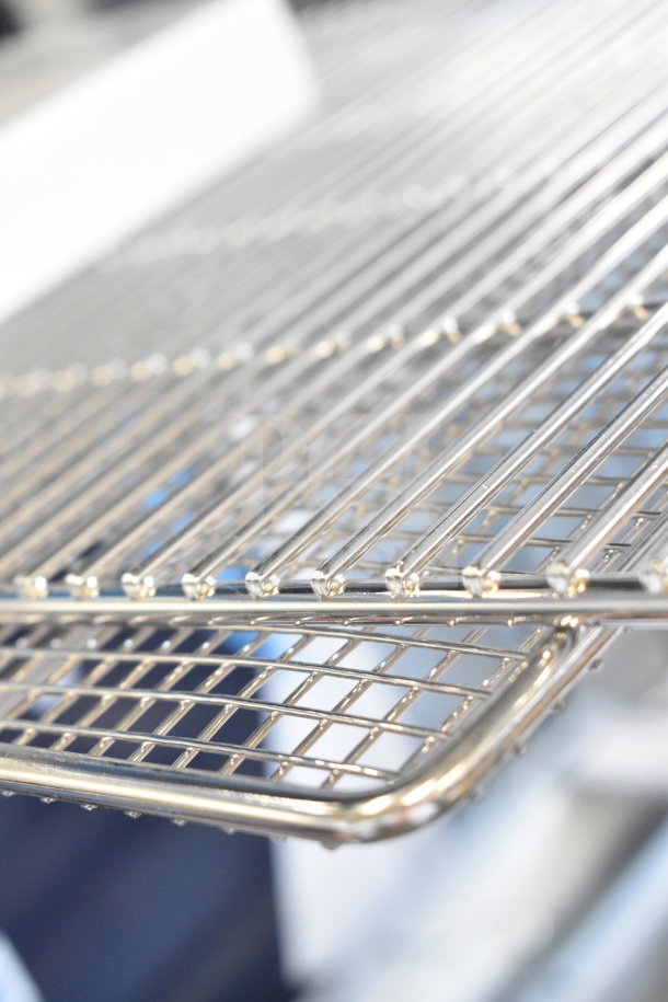 3 brand new scratch and dent items; Robot Coupe 28131 9/16" slicing disc and stainless steel racks, close-up view.