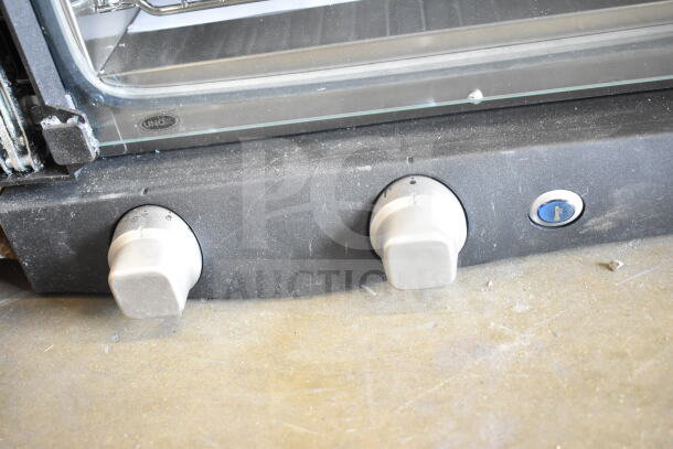 BRAND NEW Cadco XAF003-US Roberta convection oven with three shelves, manual controls, 120V, minor door scratches.