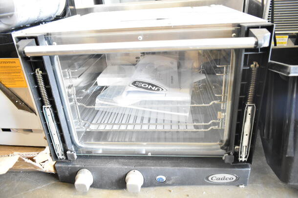 Cadco XAF003-US Roberta convection oven, 3-shelf, manual controls, model shown with outer door pane, scratch and dent condition.