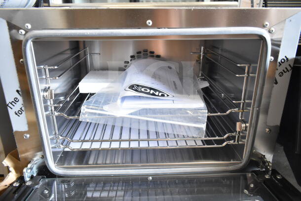 Brand new Cadco XAF003-US countertop convection oven, 3-shelf, manual controls, visible instruction manual inside.