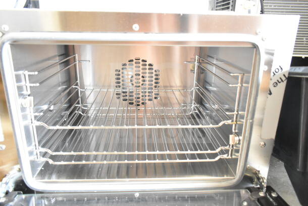 Brand new Cadco XAF003-US countertop convection oven, three shelves, scratch and dent condition, 120 volts, 1 phase.