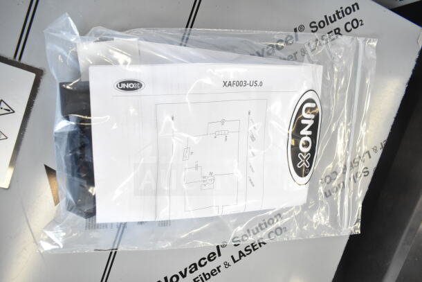 Bag with UNOX manual for Cadco XAF003-US convection oven. Visible model number XAF003-US.
