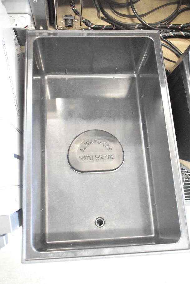 Brand new Vollrath food warmer with visible "Always Use with Water" marking; minor scratches present.