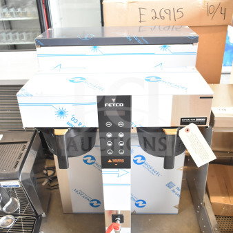 Brand new Fetco CBS-1252 Plus twin automatic coffee brewer with digital controls and plastic brew basket, minor scratches.