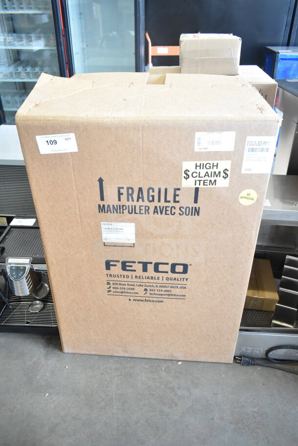 Cardboard box of a 2025 Fetco CBS-1252 Plus Series Coffee Brewer, labeled "Fragile" and "High Claim Item."