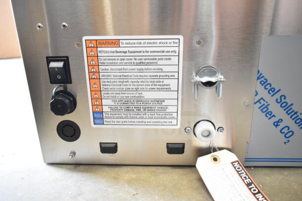 Brand new 2025 Fetco CBS-1252 Plus Series twin automatic coffee brewer with plastic brew basket, 208/240V, 1/3 phase. Warning labels visible indicate commercial use and installation guidelines.