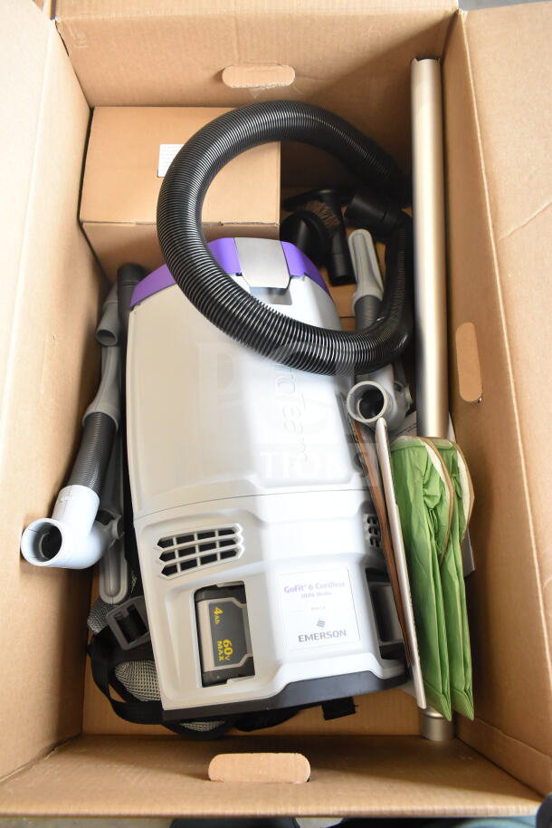 Brand new ProTeam GoFit® 6 Qt. Cordless Backpack Vacuum with ProBlade Kit in box, visible minor scratches.