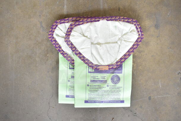 Two replacement bags for ProTeam GoFit® 6 Vacuum, showing green color, purple trim, and product markings.