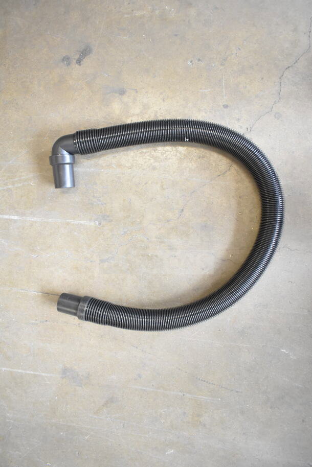 Flexible hose for ProTeam GoFit® 6 Backpack Vacuum, shown on concrete surface. Durable, corrugated design in excellent condition.