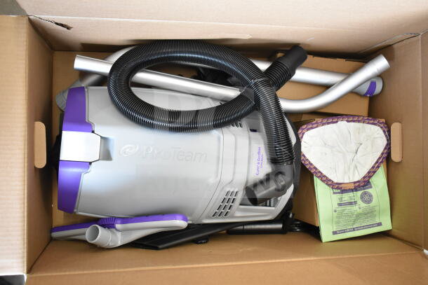 Brand new ProTeam GoFit® 6 Qt. Cordless Backpack Vacuum in box with Xover wand kit; minor scratches visible.