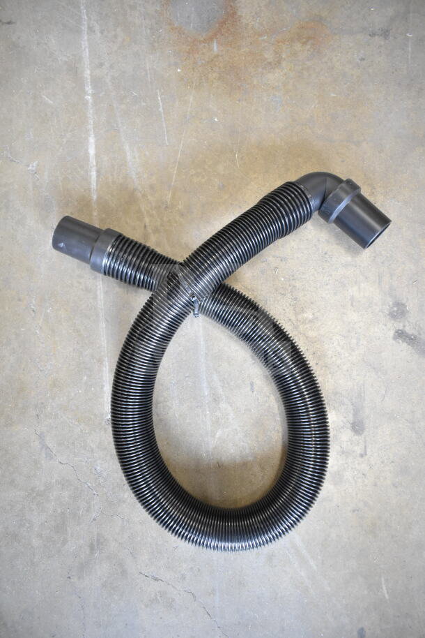 Black corrugated hose for ProTeam GoFit® 6 Cordless Backpack Vacuum, on concrete background, showing ends and flexibility.