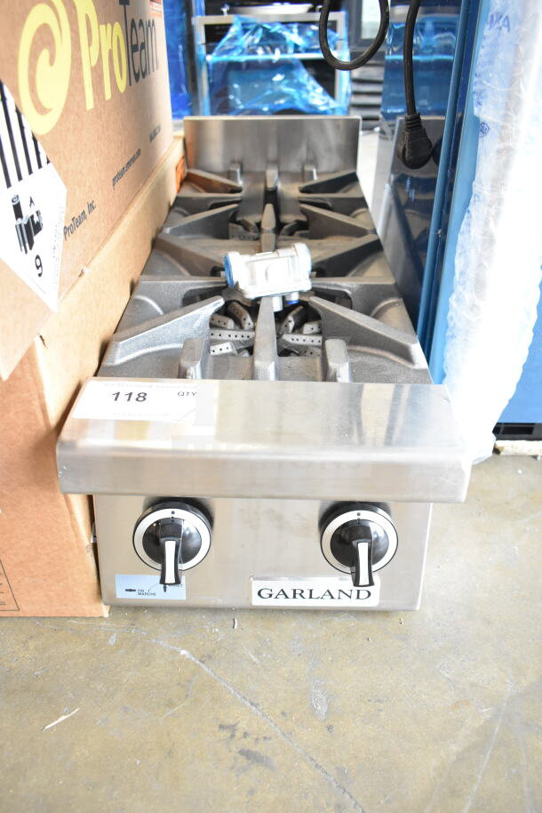 Brand new Garland GTOG12-2 2-burner propane range, 12" countertop, 60,000 BTU. Scratch and dent condition. Model label visible.