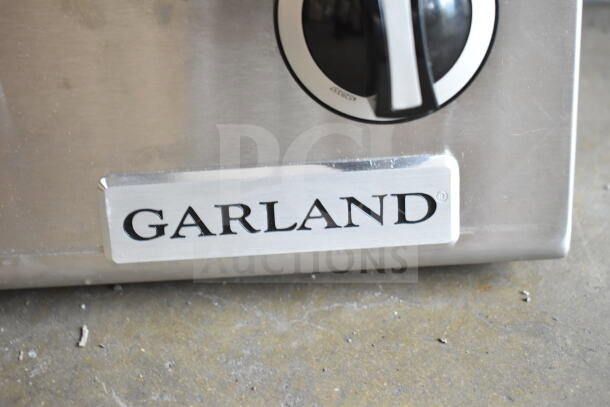 Brand new Garland GTOG12-2 2-burner propane range with 60,000 BTU, scratch, and dent condition, logo visible.