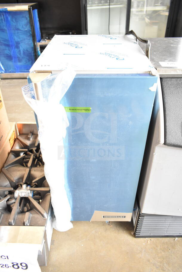 Brand new Hoshizaki AM-50BAK undercounter ice machine, 27 lb. bin, 54 lb. capacity, visible protective wrap and label.
