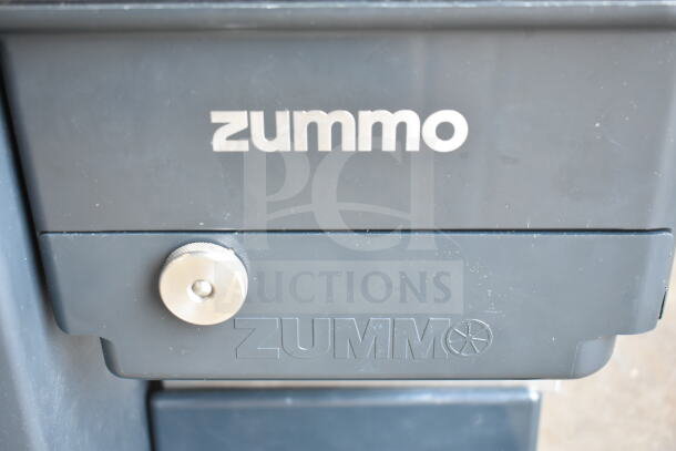 Zummo Z1-NGP orange juicer in graphite finish. Brand new with slight scratches. Processes 6 fruits/minute, 110-120V.