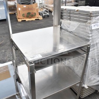 Stainless steel cart with over shelf and 2 under shelves on commercial casters, slightly used.