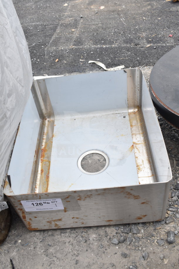 Stainless steel drop-in sink with visible rust marks, drain hole in center. Tag shows auction lot number 126, indicating used condition.