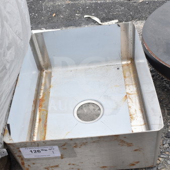 Stainless steel drop-in sink with visible rust marks, drain hole in center. Tag shows auction lot number 126, indicating used condition.