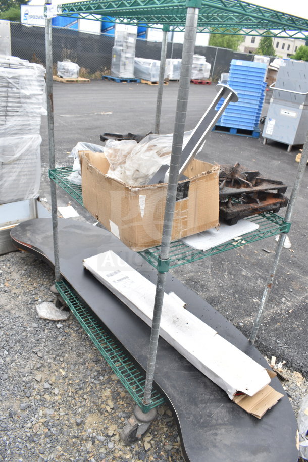 Green 3-tier wire shelving unit on casters, containing assorted items. Requires dismantling; consider freight charges.